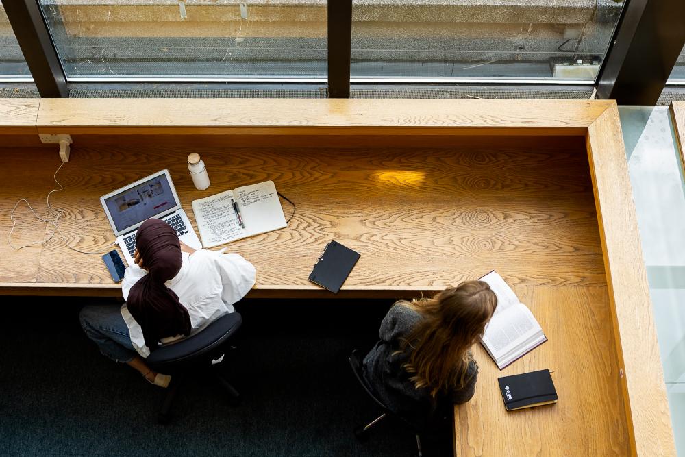 Students working at desks in the SOAS Library