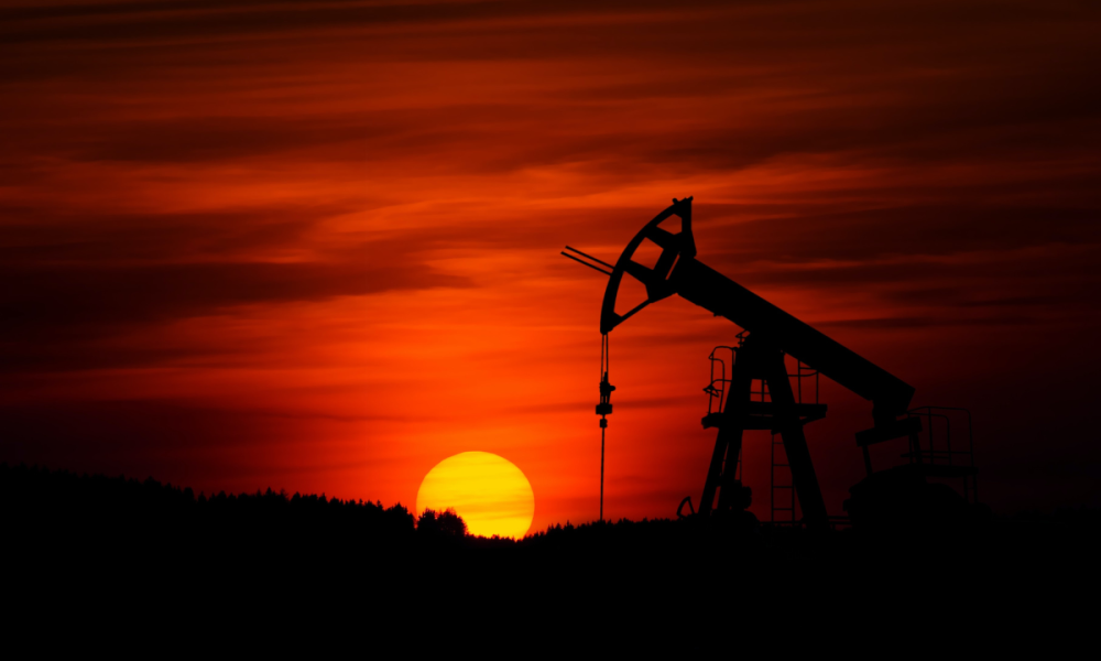 Pump-jack mining crude oil with the sunset