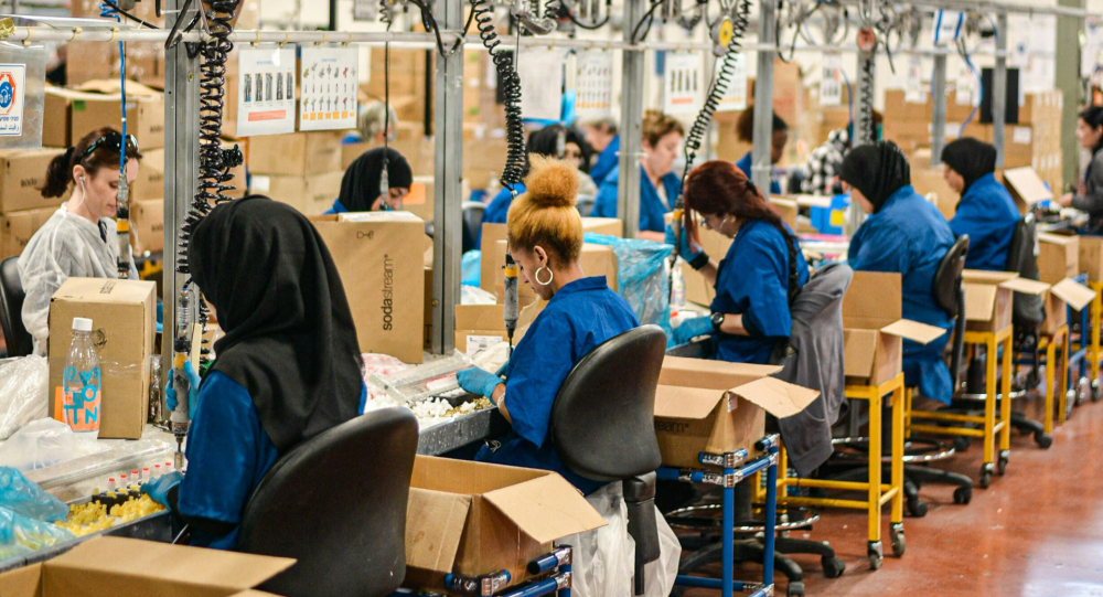 Women working on SodaSteam devices in factory.