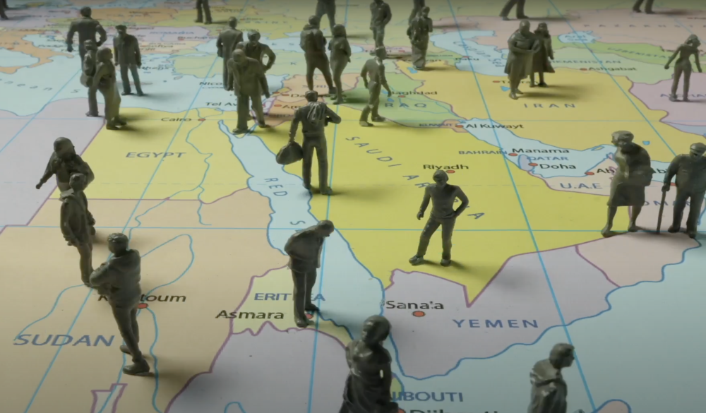 photograph of model soldiers standing on a world map